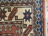 close up of a colorful oriental rug with a pattern on it