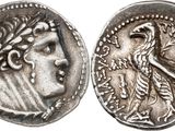 a silver coin with an image of a woman and a bird on it