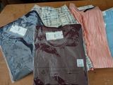 a lot of clothes that are sitting on a table