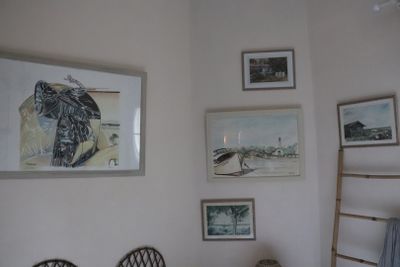 a picture of a bedroom with pictures on the wall