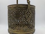 an old brass metal basket with handles and a handle