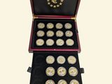 a wooden box with twelve gold coins in it