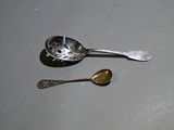a silver spoon and a silver spoon sitting on a table