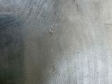 a close up of a metal plate with a hole in it