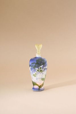a small glass vase with a flower inside of it