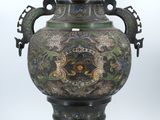 a large vase with a dragon design on it