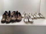 several pairs of shoes are lined up in a row on a shelf