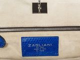 a close up of a blue and white handbag on a white surface