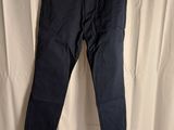 a pair of dark blue pants hanging on a hanger