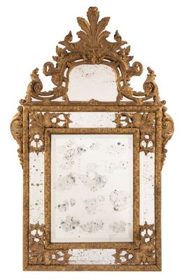 an ornately carved mirror with a gold frame on a white background