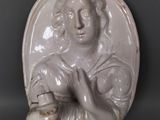 une statue représentant une femme tenant un panier rempli de nourriture