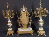 three gold and white vases sitting on top of a table