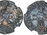 a close up of two silver coins on a white surface