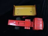 a red toy truck with a yellow box on it