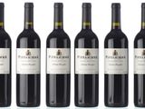 six bottles of red wine are lined up in a row