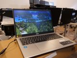 a laptop computer sitting on top of a box in a room