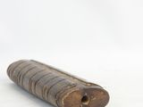 a small piece of wood that is laying on the ground