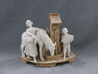 une figurine représentant un homme et une femme avec un cheval devant une horloge