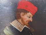 portrait of a man in a red beret holding a book