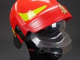 fireman helmet with visor and goggles on display on black background