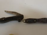 two small knives that are sitting on a table