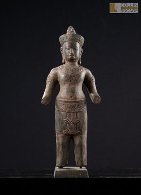 a statue of a person standing on a black surface