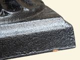 a close up of a black metal object on a white background