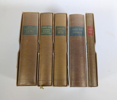 quatre livres sont alignés sur une surface blanche