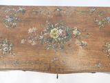 a wooden table with a floral design on it