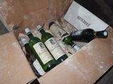 bottles of wine are in a cardboard box on the floor