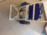 a blue and white cart with a blue handle on the floor