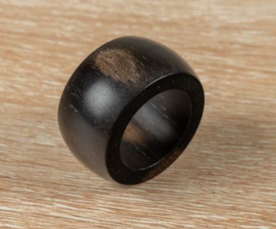 a close up of a wooden ring on a wooden surface