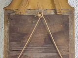 a wooden box with a rope hanging on the wall