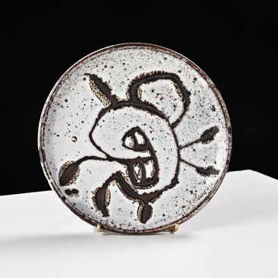 a plate with a drawing on it sitting on a table
