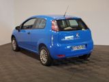 a small blue car that is parked on a checkered floor