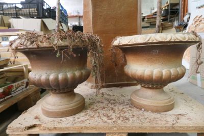 deux grands vases posés sur une table dans un magasin