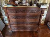 a wooden dresser with many items on top of it