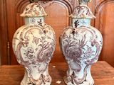 two vases that are sitting on a wooden table