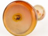 a close up of a glass vase with a flower inside of it