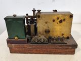a small model of a steam engine on a wooden stand