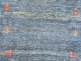 a blue rug with orange and white designs on it