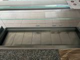 a glass display case in the middle of the floor