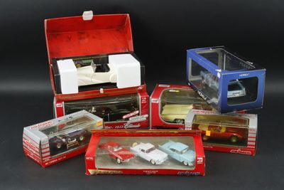 a lot of toy cars in boxes on a black surface