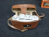 a brown leather case with a camera inside of it