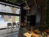 tables and chairs in a restaurant with a large glass window