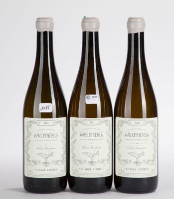 three bottles of wine sitting on top of a white table