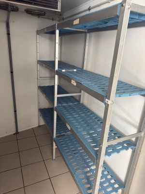 a room with shelves and a tv on the wall
