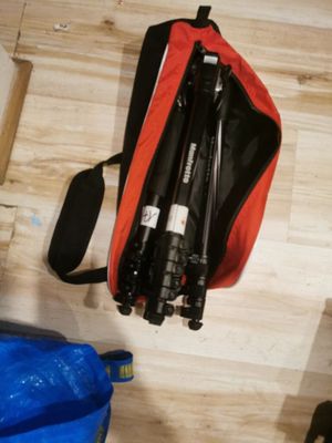 a bag with a camera and a tripod on the floor