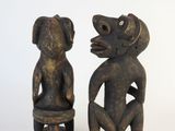 pair of wooden figures of a monkey and a monkey sitting on a stool