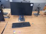 a computer desk with a keyboard and monitor on it